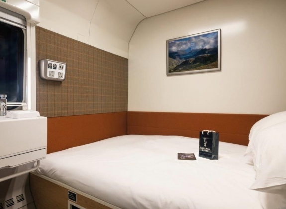 A double bed inside a train cabin