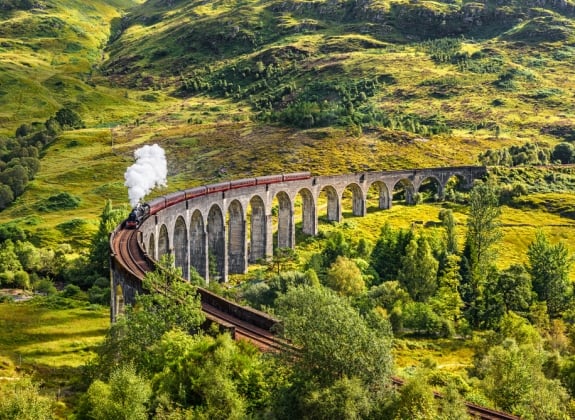 The Jacobite Steam Train A steam train travels over a viaduct