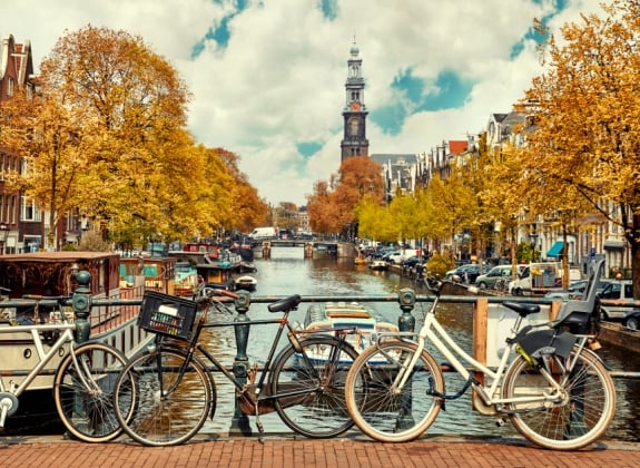 bikes in amsterdam leaned against the bridge