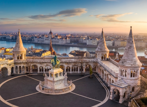 Budapest, Hungary - The famous Fisherman's Bastion at sunrise with statue of King Stephen I and Parliament of Hungary at background