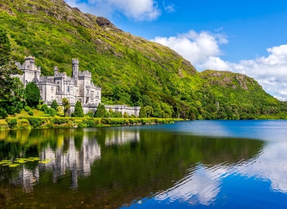 Kylemore Abbey, beautiful castle like abbey reflected in lake at the foot of a mountain. Benedictine monastery founded in 1920, in Connemara, Ireland