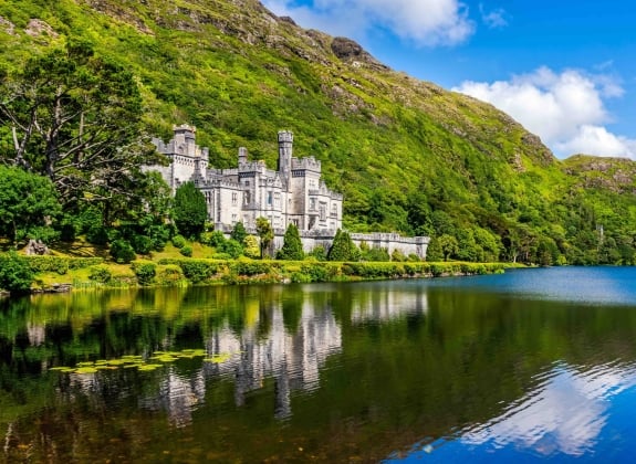 Kylemore Abbey, beautiful castle like abbey reflected in lake at the foot of a mountain. Benedictine monastery founded in 1920, in Connemara, Ireland