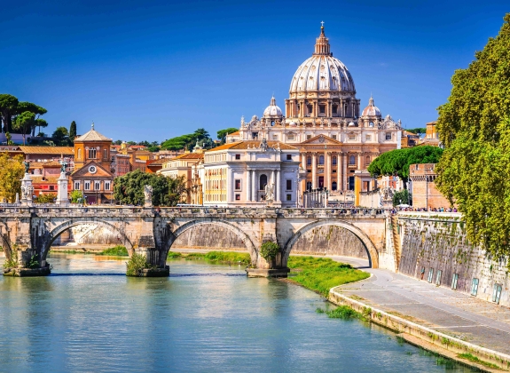 Rome, Italy. Vatican dome of Saint Peter Basilica and Sant'Angelo Bridge, over Tiber river.