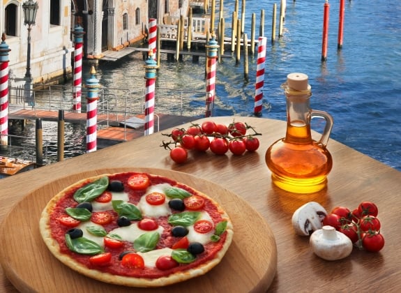 Classic Italian pizza in Venice against canal, Italy