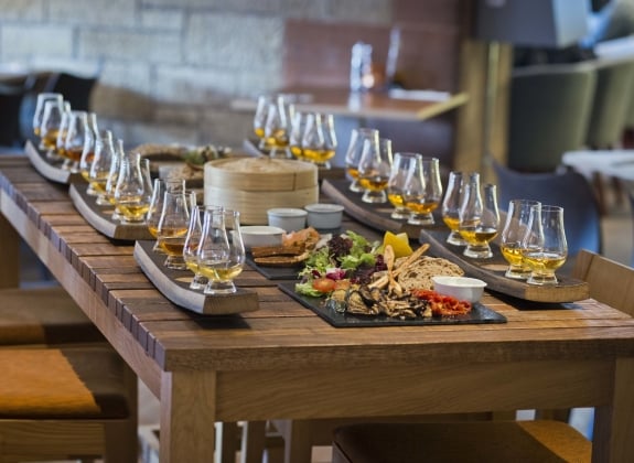scotch whiskey experience table of glasses and food
