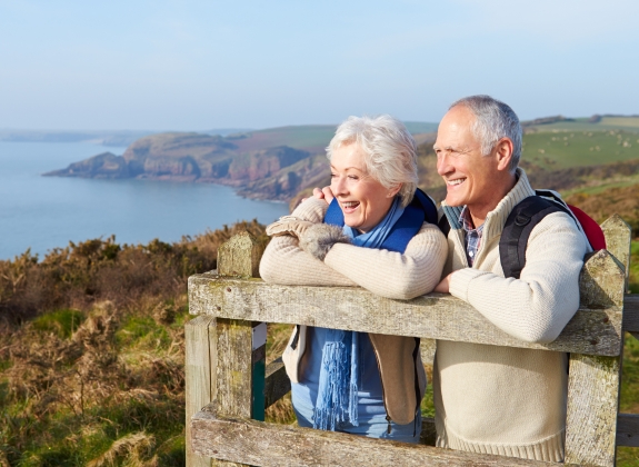 Senior Couple Walking Along Coastal Path