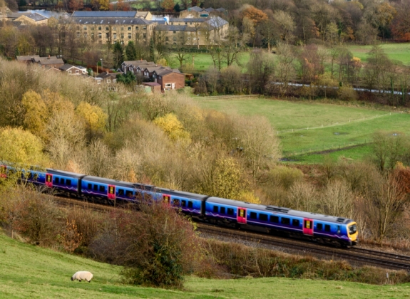 A train travels through the British countryside