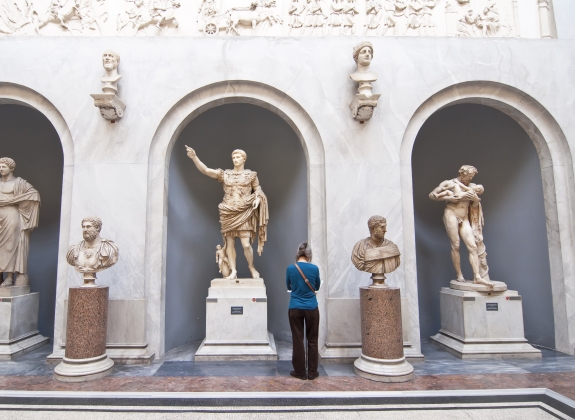 Tourists visiting the statues in the halls of the Vatican Museums in Rome, Italy