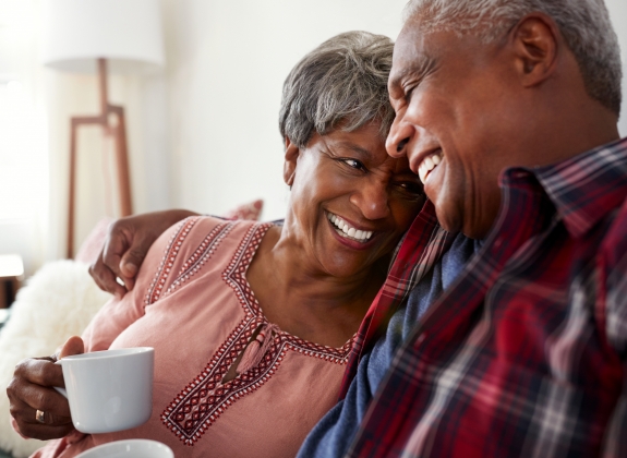 happy couple planning train trip while drinking tea