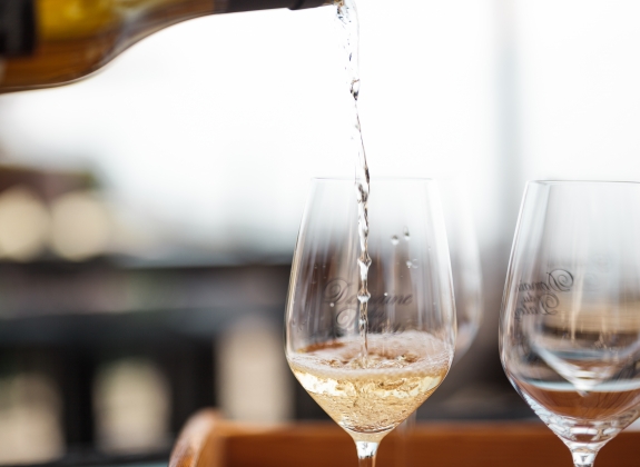 wine being poured into glasses during a wine tasting tour