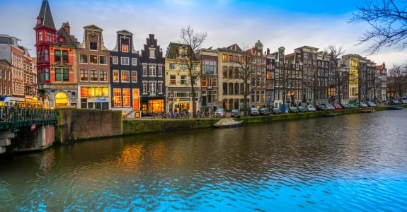 Evening city view of Amsterdam, the Netherlands with Amstel river