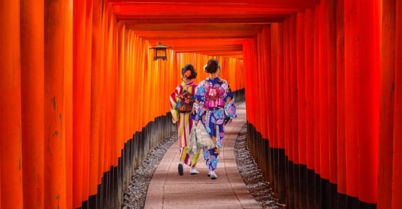 Women in traditional japanese kimonos walking at Fushimi Inari Shrine in Kyoto, Japan
