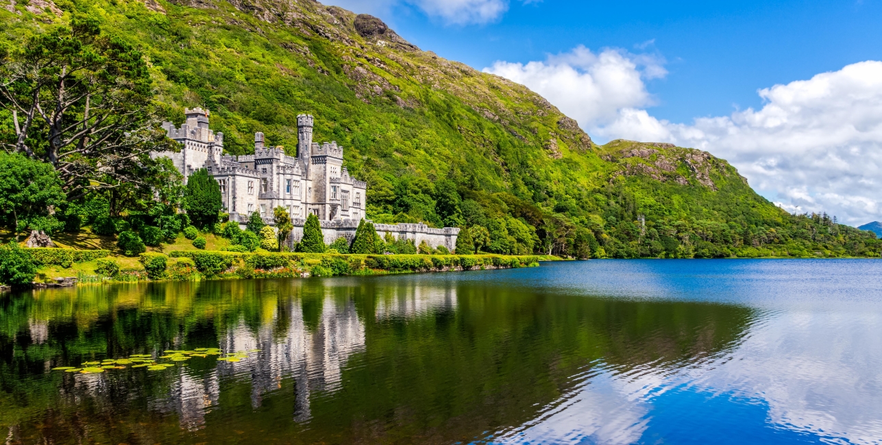 Kylemore Abbey, beautiful castle like abbey reflected in lake at the foot of a mountain. Benedictine monastery founded in 1920, in Connemara, Ireland