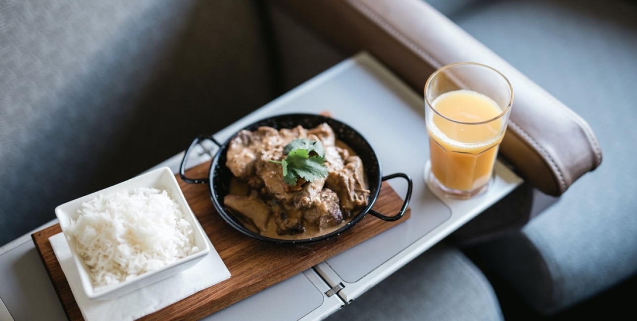 Dining onboard The Overland - Red Premium A tray with onboard meal of curry