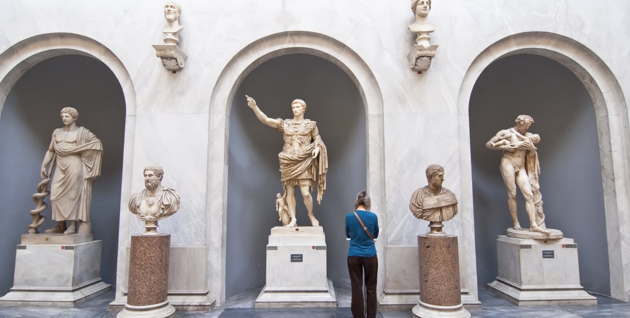 Tourists visiting the statues in the halls of the Vatican Museums in Rome, Italy