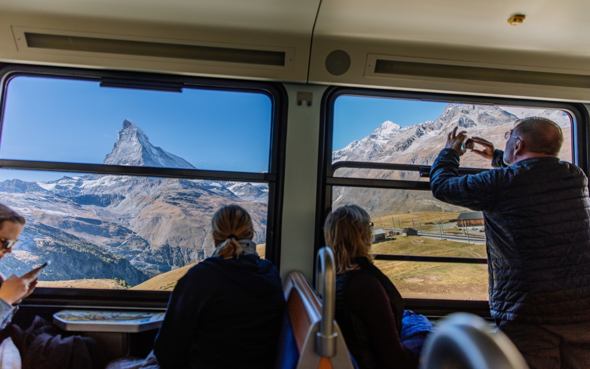 Onboard the Gornergrat Tourists admire the Alpine view from their window