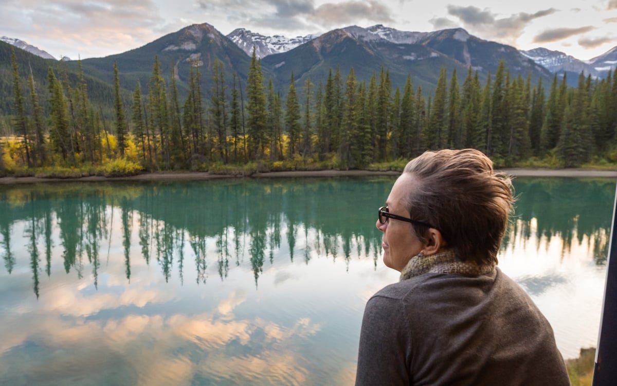 Man on Rocky Mountaineer's outdoor viewing platform