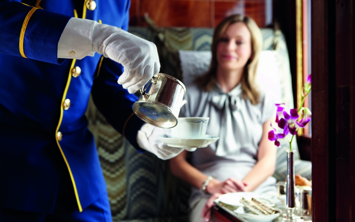 Afternoon Tea on the Venice Simplon-Orient-Express Onboard the train, a steward serves customer afternoon tea