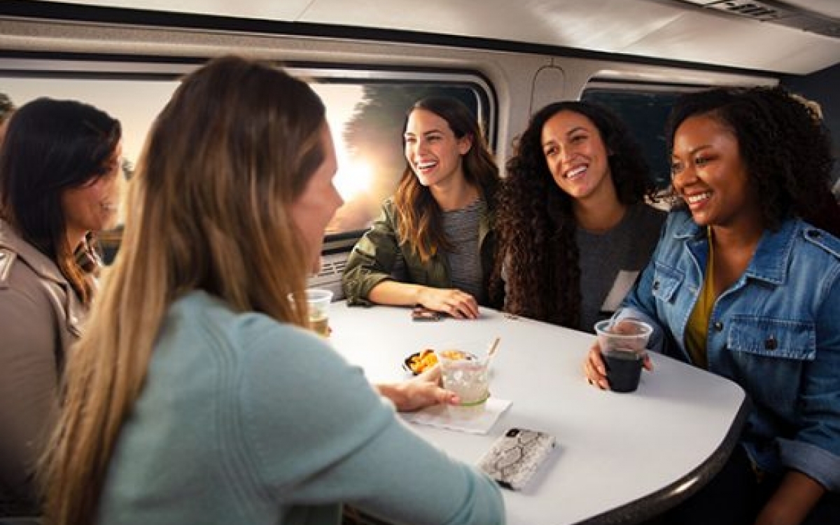friends at a dining room table onboard Amtrak trains
