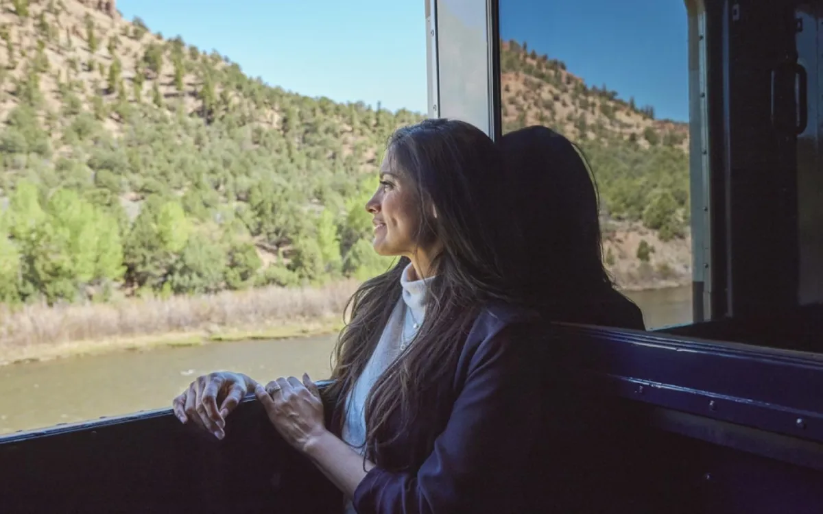 Rocky Mountaineer's Canyon Spirit Train woman looking out the windowonboard