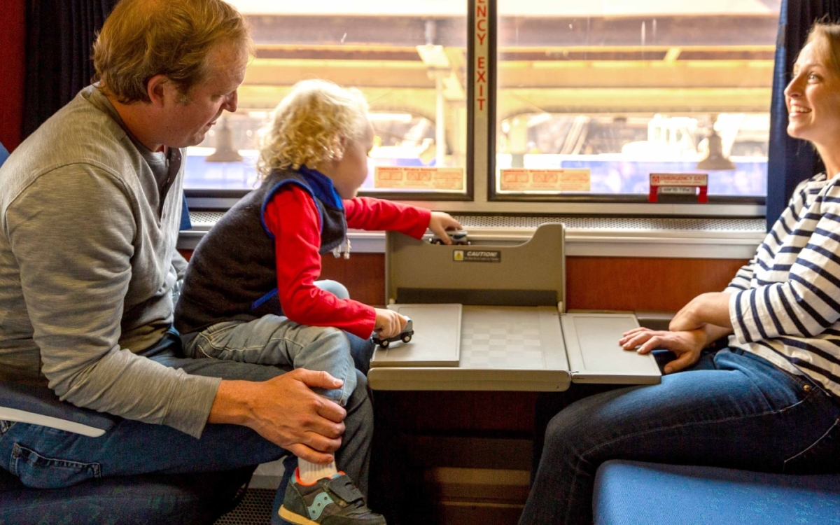 family relaxing in Amtrak's family bedroom in daytime