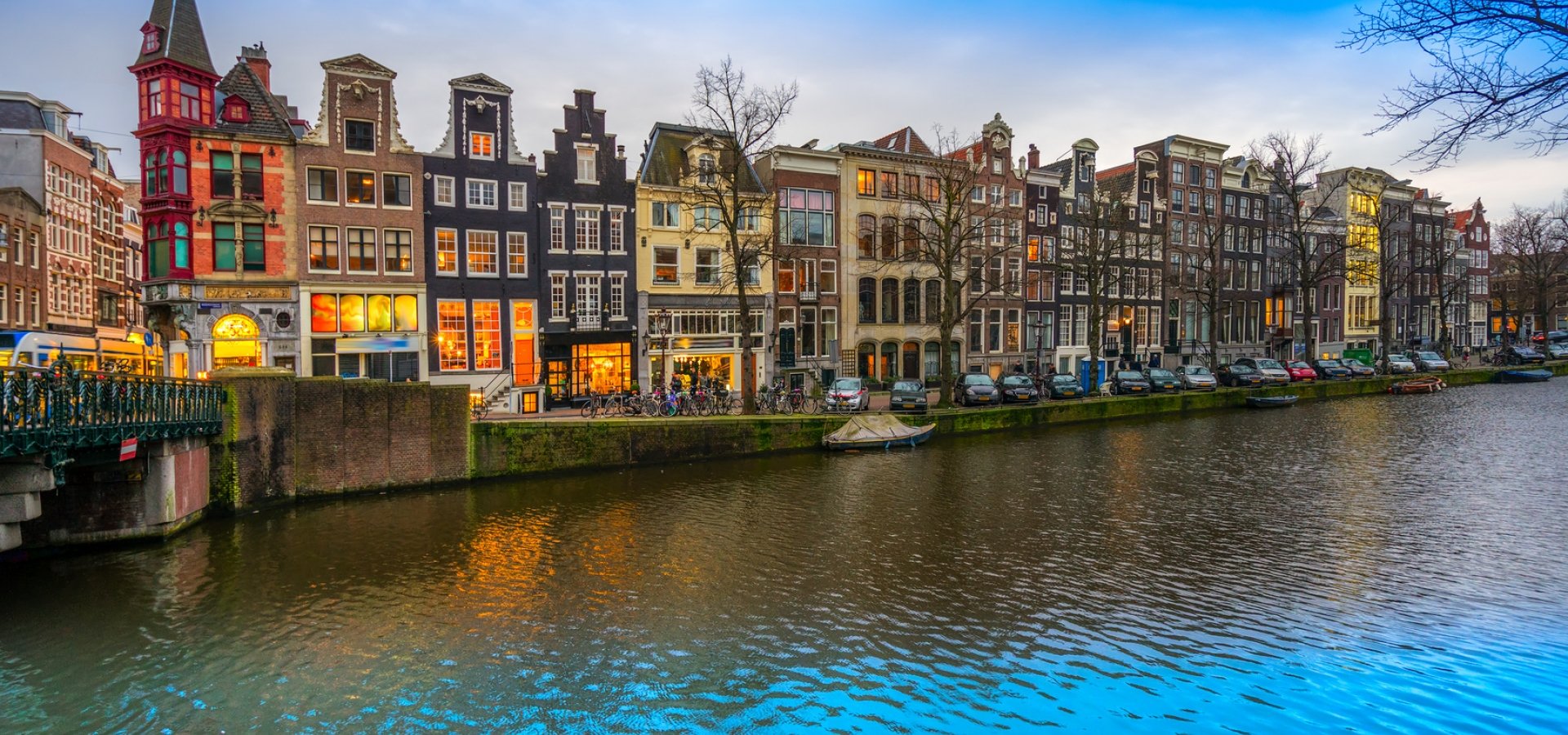 The Rijksmuseum in Amsterdam, Netherlands. Evening city view of Amsterdam, the Netherlands with Amstel river