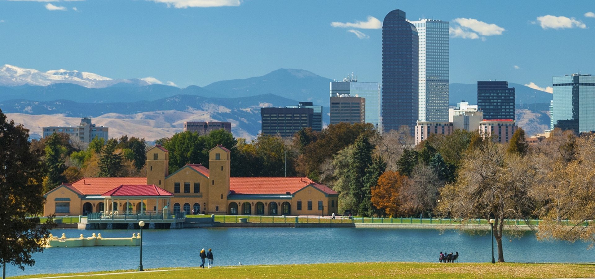 Denver skyline, clouds, mountains, and City Park with a lake Denver skyline, clouds, mountains, and City Park with a lake