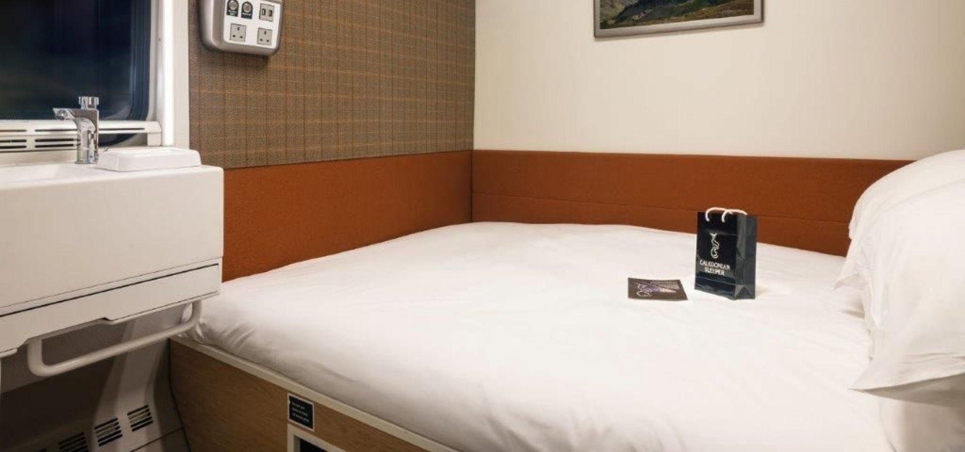 A double bed inside a train cabin