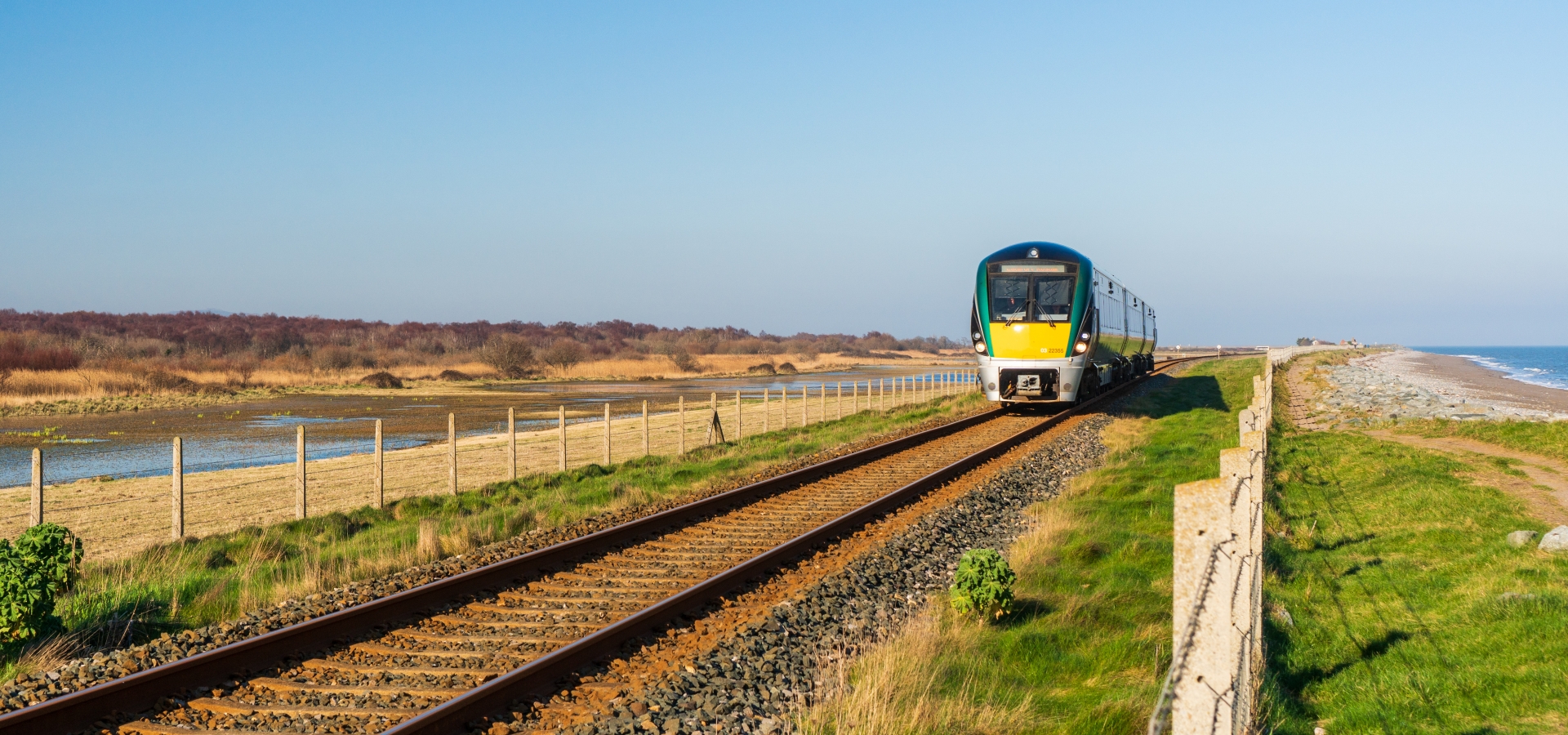 Irish Rail train coasting through a sunny day