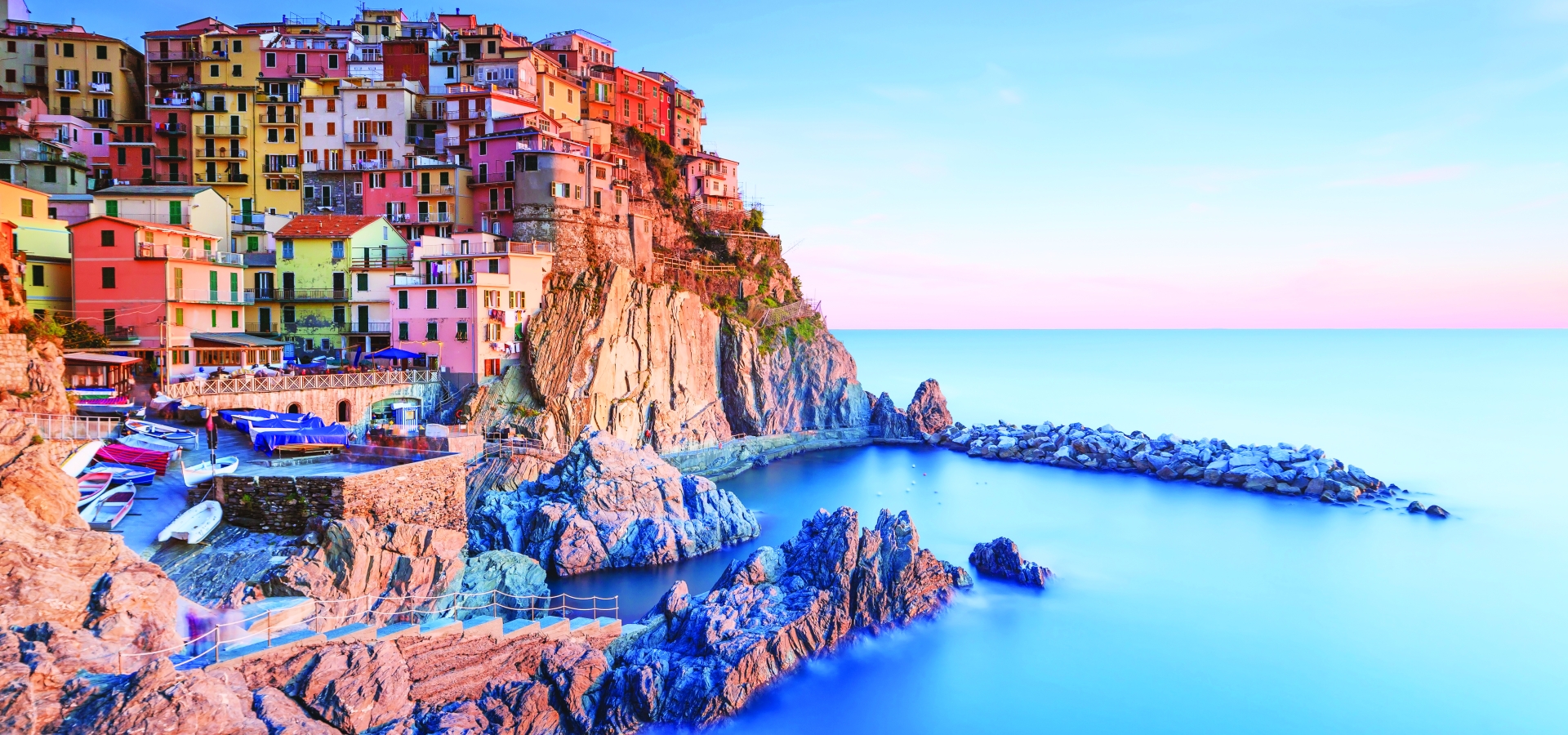 Manarola village, rocks and sea at sunset in Cinque Terre