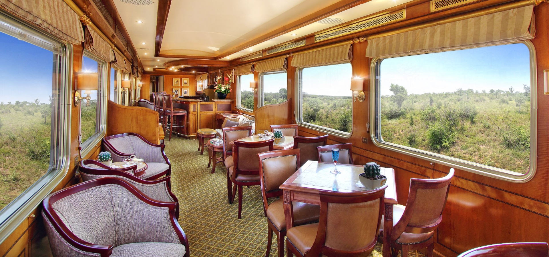 Insidea  train carriage, with comfortable chairs and tables