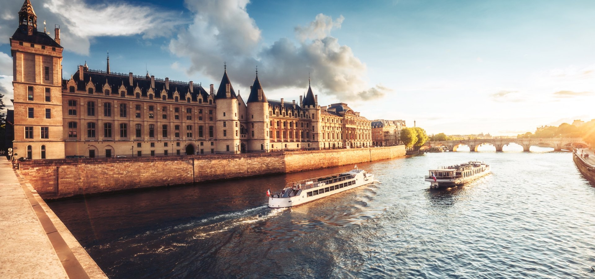 Dramatic sunset over river Seine and Conciergerie in Paris, France, with cruise boats and Pont Neuf. Colourful travel background. Romantic cityscape. Dramatic sunset over river Seine and Conciergerie in Paris, France, with cruise boats and Pont Neuf. Colourful travel background. Romantic cityscape.