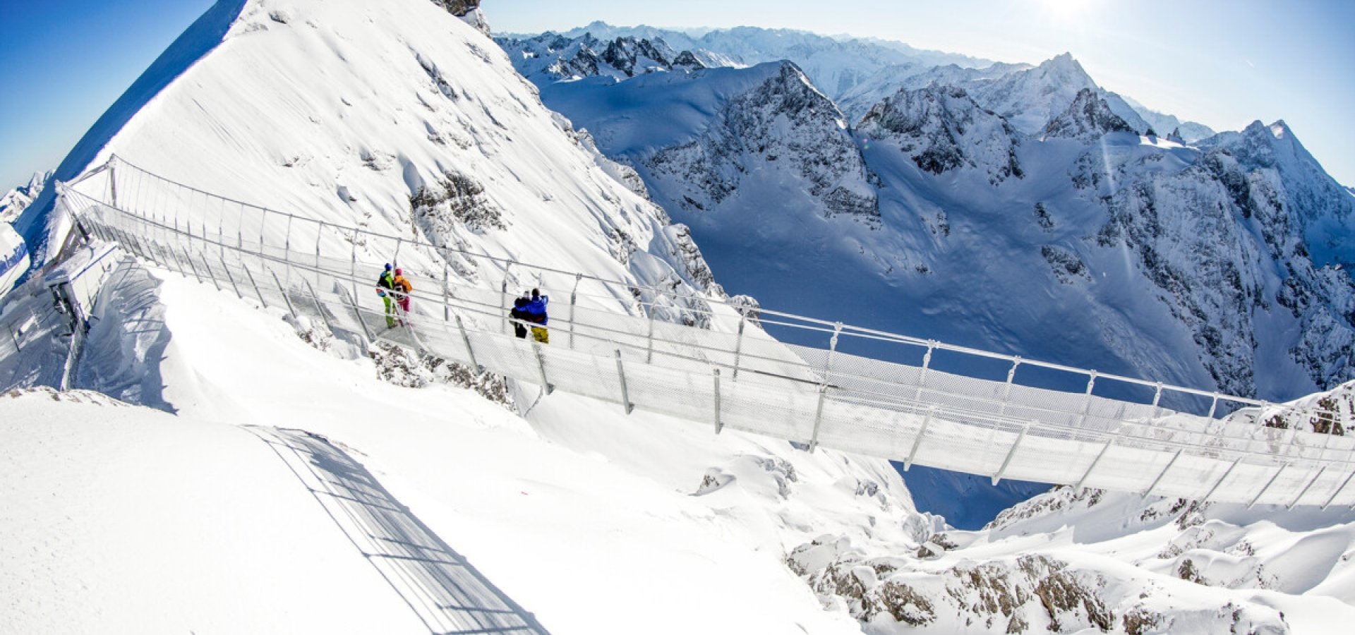 a walk way on the peaks of a snowy mountain