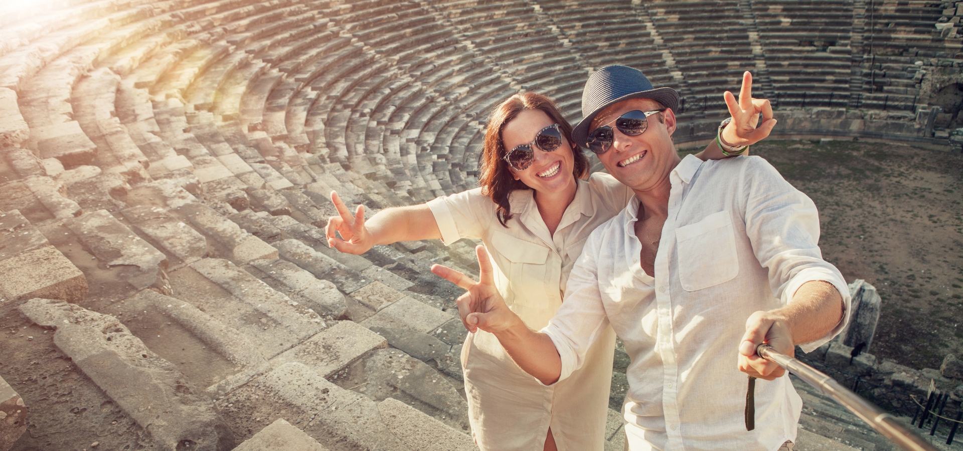 Positive young couple take selfie photo in Side antique amphitheater