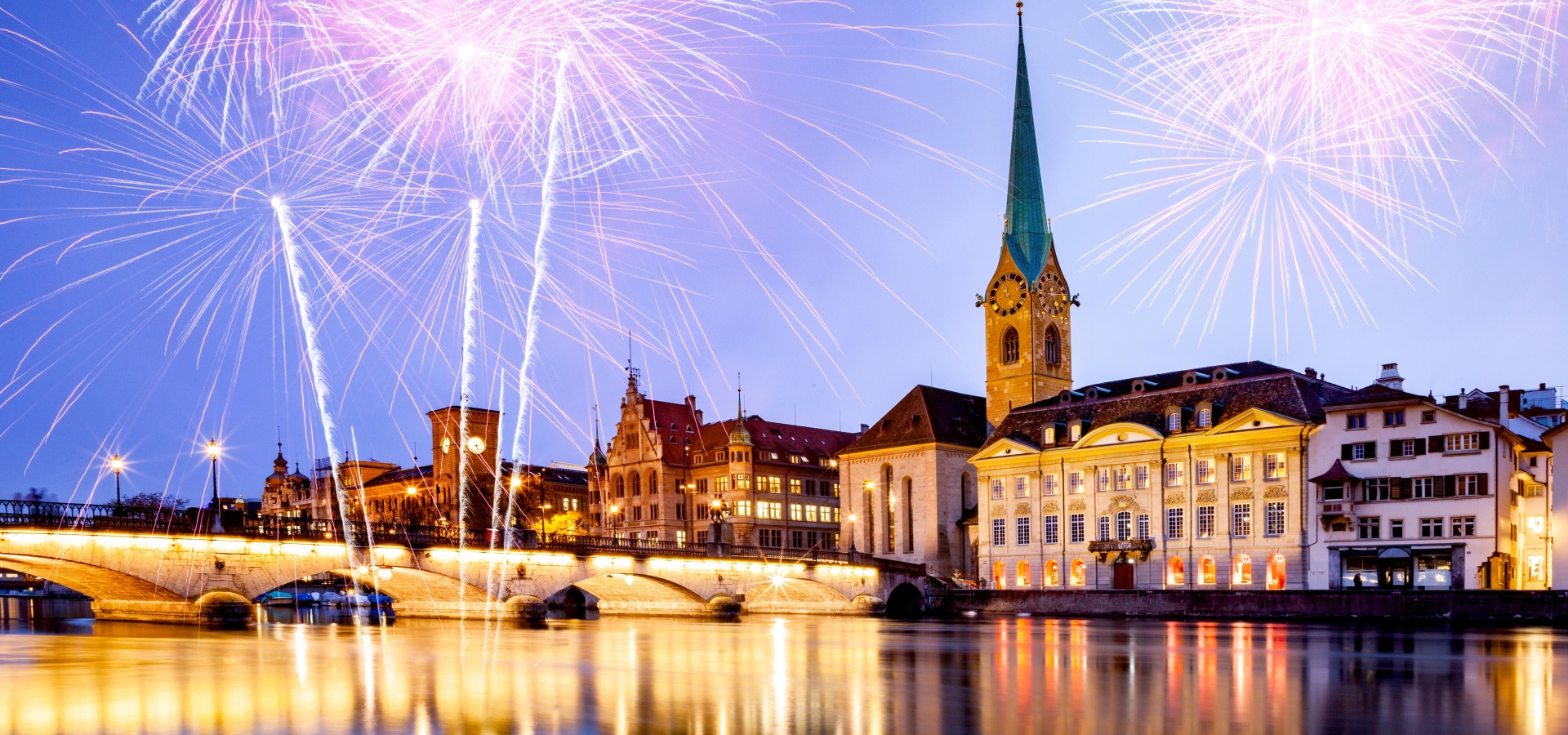 new year fireworks over Zurich city center with famous Fraumunster and Grossmunster Churches and river Limmat at Lake Zurich, Canton of Zurich, Switzerland