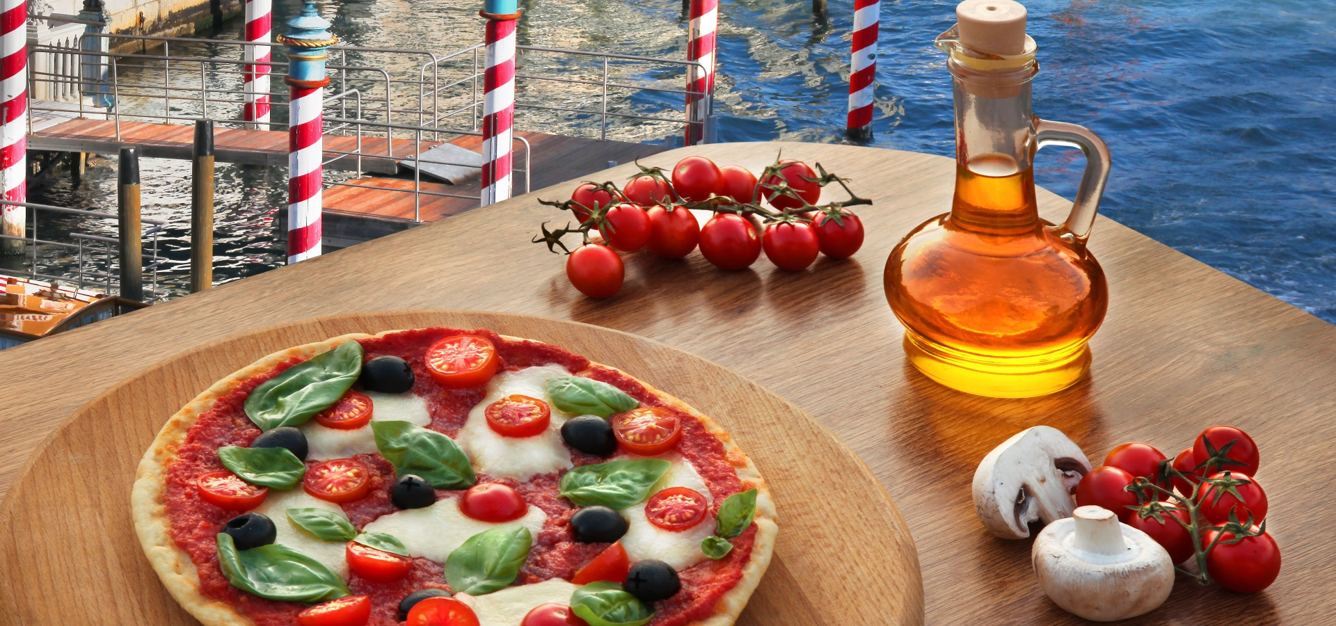 Classic Italian pizza in Venice against canal, Italy