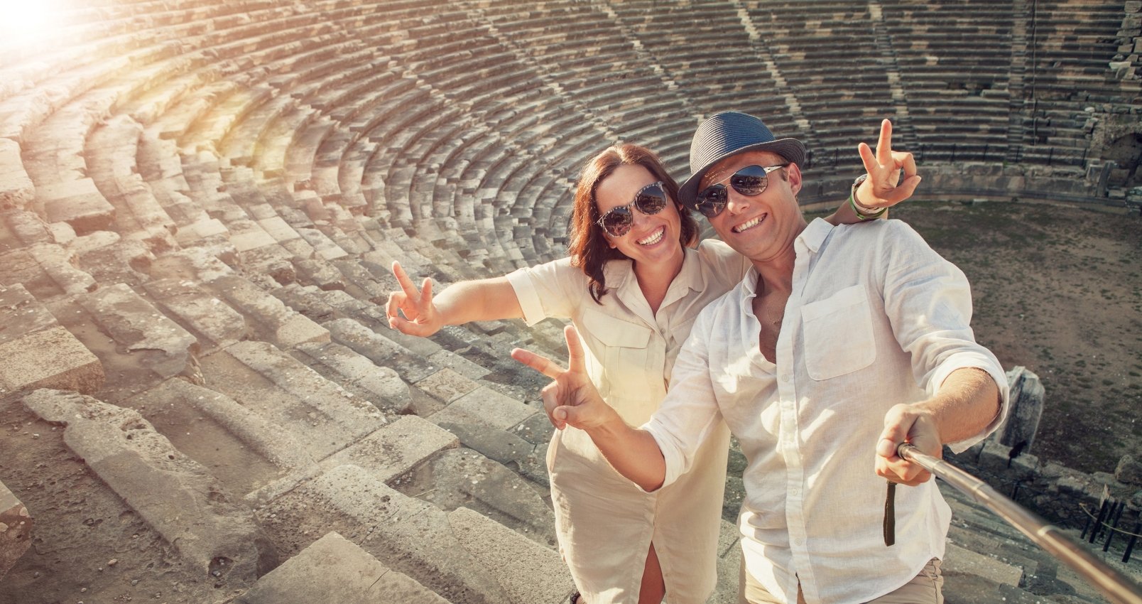 Positive young couple take selfie photo in Side antique amphitheater