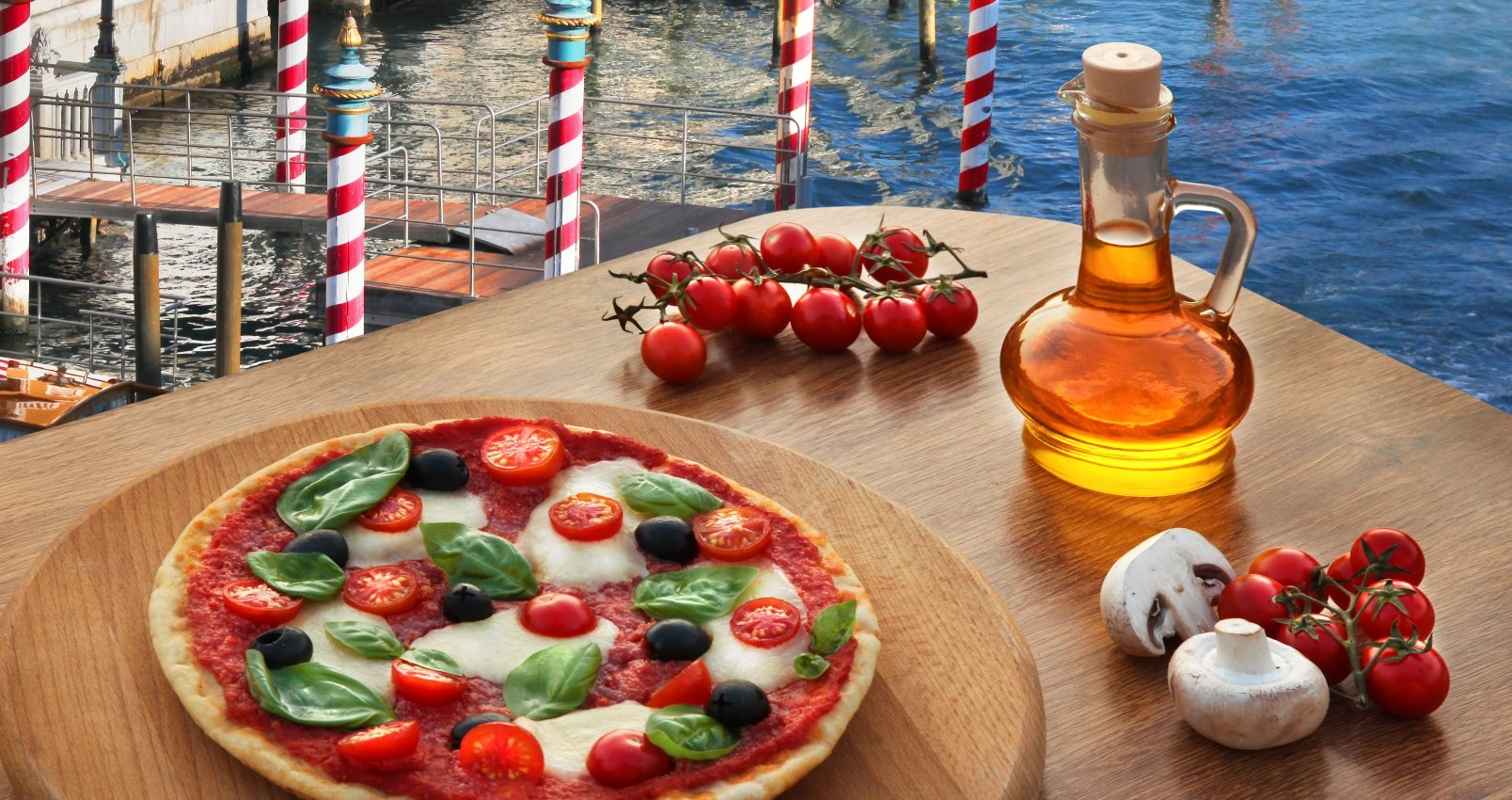 Classic Italian pizza in Venice against canal, Italy