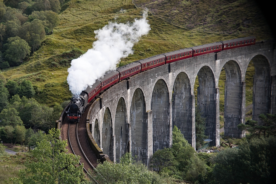 Jacobite Steam Train traveling over the Glenfinnan Viaduct