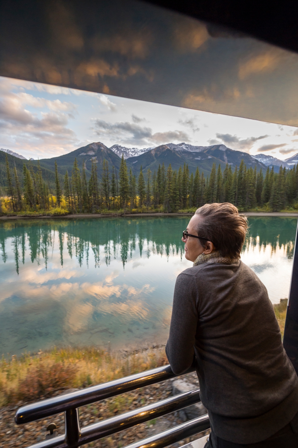 Man on Rocky Mountaineer's outdoor viewing platform