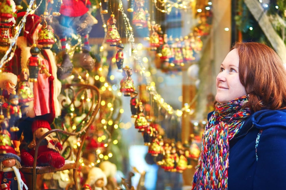 woman window-shopping-at a Christmas-market